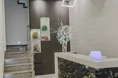 a lobby with a staircase and a vase with flowers at Cartagena Royal Hotel Boutique in Cartagena de Indias