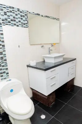 a bathroom with a white toilet and a sink at Departamento Bocagrande cerca a playas in Cartagena de Indias