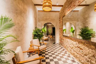 a lobby with a checkered floor and plants at Casa Del Pozo Boutique - Full House in Cartagena de Indias