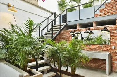 a brick building with a staircase and some plants at Santuario Getsemani Hostel in Cartagena de Indias