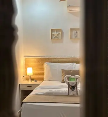 a bedroom with a bed with a scale on it at Hotel La Magdalena in Cartagena de Indias