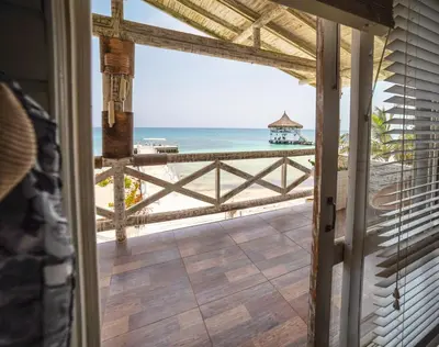 a view of the beach from the porch of a house at Quinta del Mar Sunset in Isla Mucura