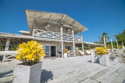 a building with yellow flowers on a wooden deck at Quinta del Mar Sunset in Isla Mucura