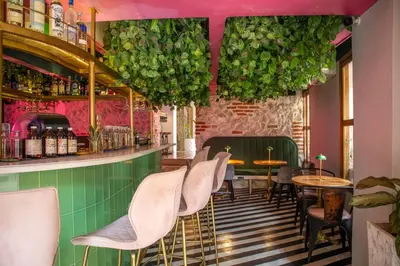 a restaurant with pink walls and chairs and a bar at Hotel Casa La Factoria by Faranda Boutique, a member of Radisson Individuals in Cartagena de Indias