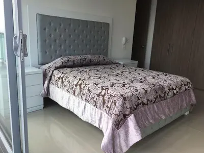 a bedroom with a bed with a purple bedspread at Luxury Infinitum in Cartagena de Indias