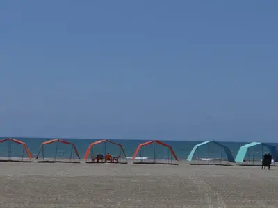 a group of tents on a beach near the ocean at Morros Vitri Cartagena in Cartagena de Indias