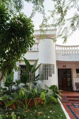 a white building with a balcony in the yard at Mucura Hotel & Spa in Cartagena de Indias