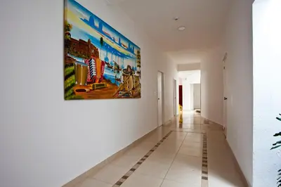 a hallway with a large painting on the wall at Mucura Hotel & Spa in Cartagena de Indias