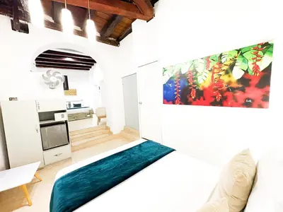 a living room with a large painting on the wall at Hotel AT THE PARK in Cartagena de Indias