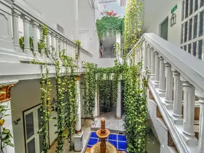 a hallway of a building with lots of plants at Hotel AT THE PARK in Cartagena de Indias
