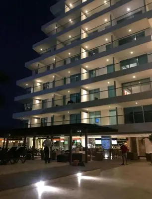 a large building with people standing outside at night at Apartamento seaway 935 Morros, La Boquilla in Cartagena de Indias