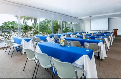 a room with blue tables and chairs and a screen at Apartamento seaway 935 Morros, La Boquilla in Cartagena de Indias
