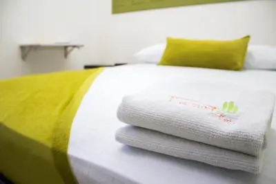 a pile of towels sitting on top of a bed at Terra Toscana Hotel in Mangue