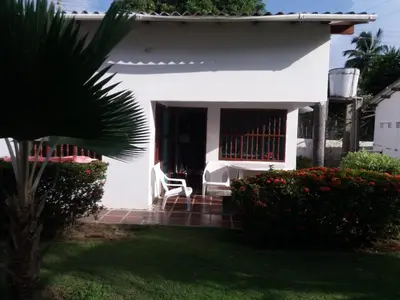 a white chair sitting on the porch of a house at Cabaña Coveñas Punta Bolivar in Coveñas