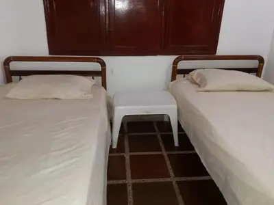 two beds sitting next to each other in a room at Cabaña Coveñas Punta Bolivar in Coveñas