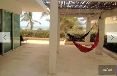 a hammock in a room with a view of the ocean at Amplio apt de 3 alcobas edificio primera linea de playa in Cartagena de Indias