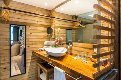 a bathroom with a sink on a wooden wall at Hotel Isla del Encanto in Baru