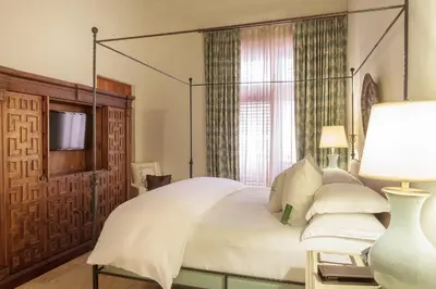a bedroom with a large white bed with a canopy at Hotel Casa San Agustin in Cartagena de Indias