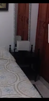 a bedroom with a bed and a mirror on the wall at Casa Fanny in Cartagena de Indias