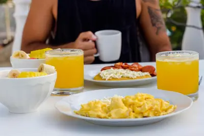 a table with plates of breakfast food and two glasses of orange juice at Cartagena Legends in Cartagena de Indias