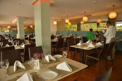 a dining room with tables and people in a restaurant at Modern 3 Bedroom Apartment with sea-beach view in Cartagena de Indias