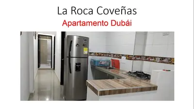 a kitchen with a stainless steel refrigerator at La Roca Coveñas Apartamentos in Coveñas