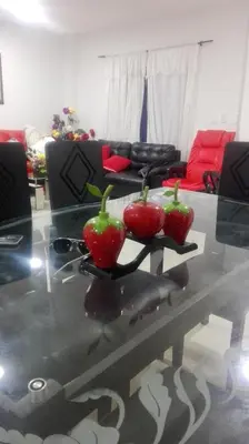 two tomatoes on a glass table in a living room at La Roca Coveñas Apartamentos in Coveñas