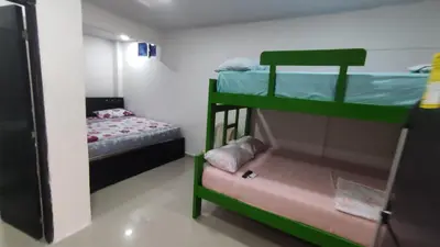 a room with two bunk beds and a small bed at La Roca Coveñas Apartamentos in Coveñas