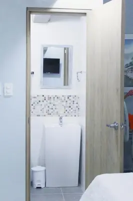 a bathroom with a toilet and a tv on the wall at Casa Anita in Cartagena de Indias