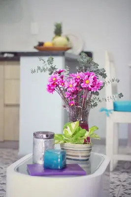 a vase with purple flowers on a table at Casa Anita in Cartagena de Indias