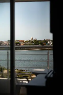 a view of a body of water from a window at Bahia 79 Apartasuites Cerca al Centro in Cartagena de Indias
