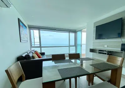 a living room with a table and a television at Apartamento en Cartagena con Vista al Mar in Cartagena de Indias