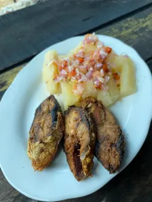 a plate of food with meat and vegetables on it at Tipiland baru la casa del mono in Playa Blanca