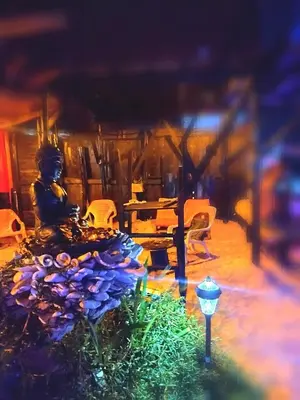 a room with a table with purple flowers on it at Tipiland baru la casa del mono in Playa Blanca