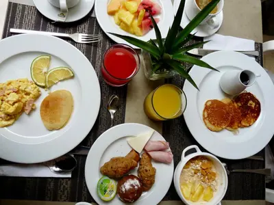 a table with plates of breakfast food on it at Delirio Hotel in Cartagena de Indias