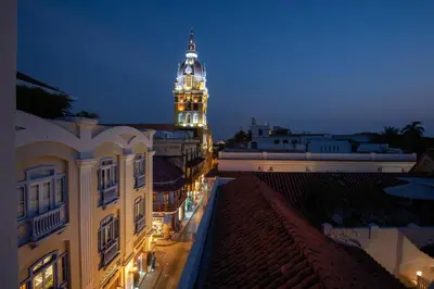 a building with a clock tower at night at Delirio Hotel in Cartagena de Indias
