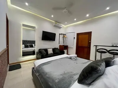 a hotel room with two beds and a couch at Luxury Suite Room in Cartagena de Indias
