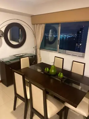 a dining room with a table and chairs and a window at Palmetto Suite Superior 3901 in Cartagena de Indias