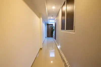a hallway with white walls and a tile floor at Hotel Amoek in Cartagena de Indias