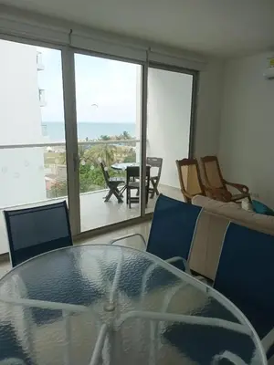 a dining room with a glass table and a view of the ocean at Cartagena Beach Condo - 1400 sq. Ft. (130 m2) in Cartagena de Indias