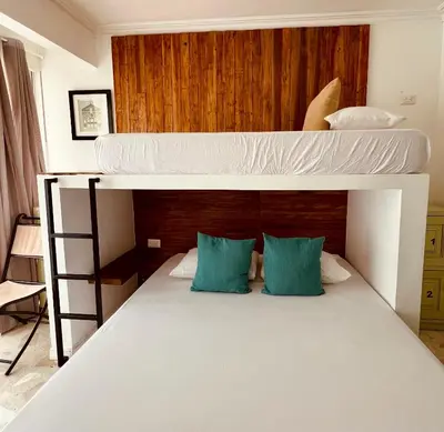 a bedroom with two bunk beds with blue pillows at Peregrinos Hostel Cartagena de Indias in Cartagena de Indias