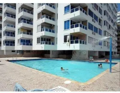 a swimming pool in front of a large apartment building at Apartamento 1101 Edificio Nuevo Conquistador in Cartagena de Indias