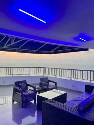 a room with chairs and a table and the ocean at Palmetto Penthouse Deluxe Beautiful view and sunset floor 39 in Cartagena de Indias