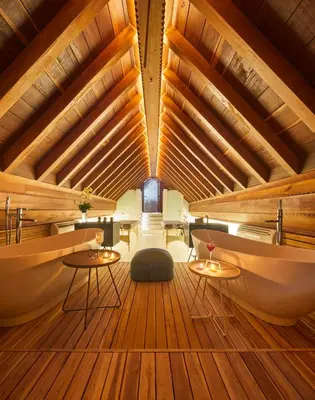a room with wooden ceilings and tables and chairs at Hotel Boutique Casona del Colegio in Cartagena de Indias