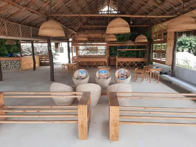 a pavilion with benches and tables and chairs at Hotel Arena Beach Cartagena in Cartagena de Indias