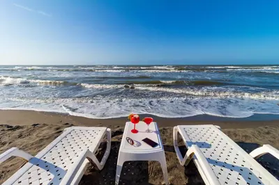 two chairs and a table on the beach at Hotel Arena Beach Cartagena in Cartagena de Indias