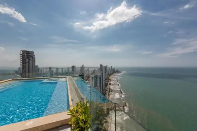 a swimming pool on top of a building next to the ocean at MURANO ELITE NEW OCEAN FRONT DUPLEx in Cartagena de Indias