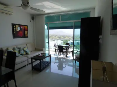 a living room with a couch and a table at Costa Azul Suites 905 in Santa Marta