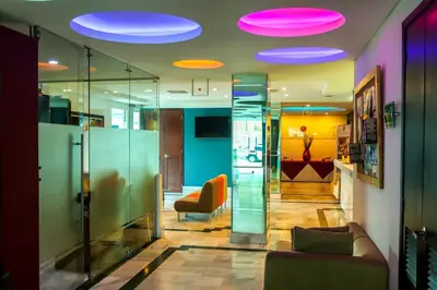 a lobby with glass walls and purple lights at Hotel Buenos Aires in Cartagena de Indias