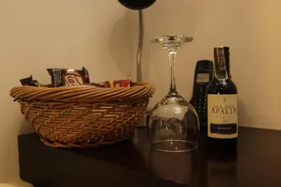 a bottle of wine and a basket on a table at Hotel Buenos Aires in Cartagena de Indias